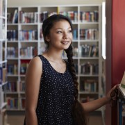 Woman standing with a dreamy look in library 